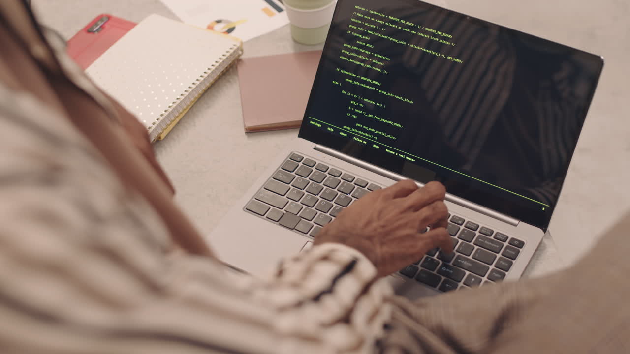 IT Student Writing Programming Code on Laptop