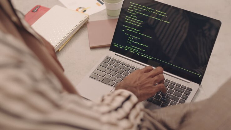IT Student Writing Programming Code on Laptop