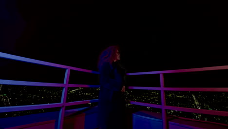 woman on a rooftop at night