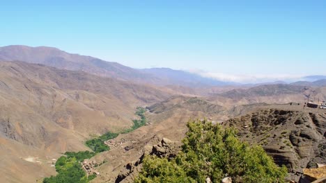 4k footage of panorama view to atlas mountain with goats walking, morocco, north africa-1