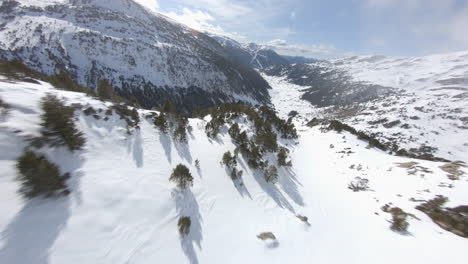 racing drone flying over on mountainside with incles valley in background, pyrenees, andorra