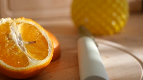 close up of sliced orange on wooden board