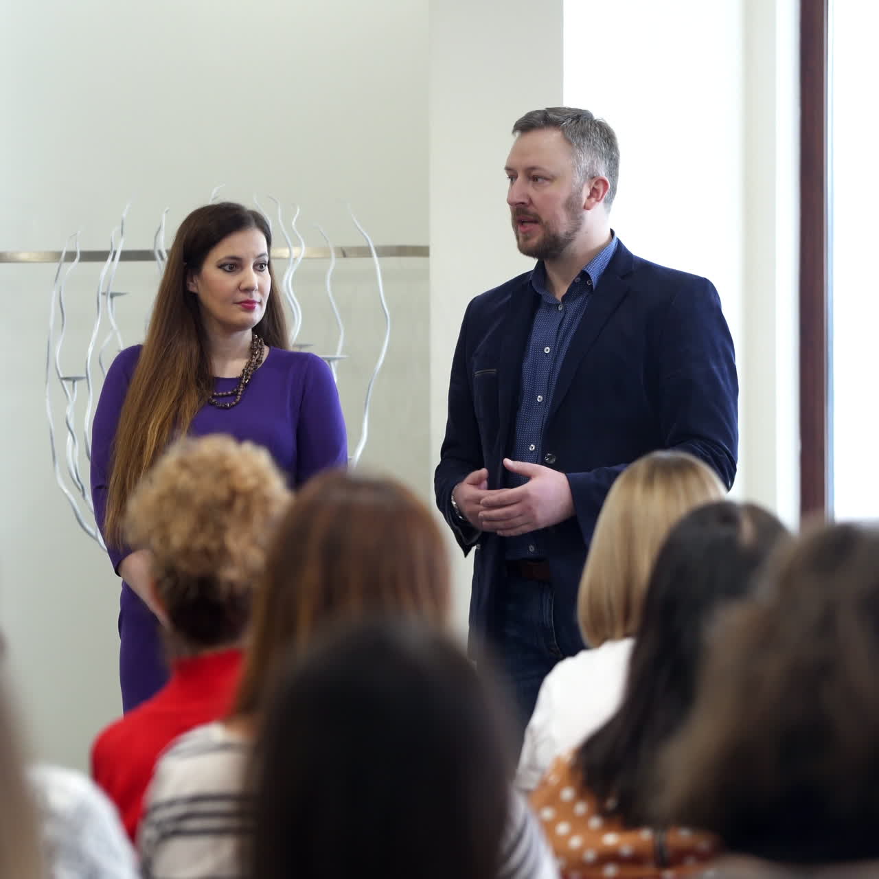 Successful educator speaking to listeners. Manager explaining business problems during the conference. Public seminar in auditorium.