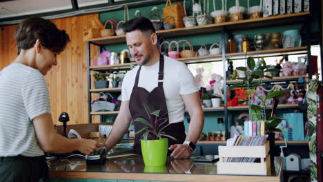 customer purchasing a plant at a florist shop