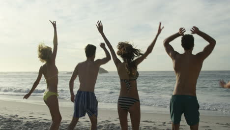 friends jumping on the beach