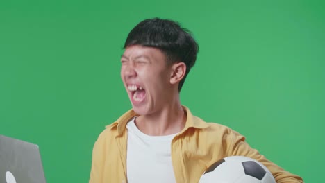 노트북 에서 축구 경기 를 보고 있는 흥분 한 십대