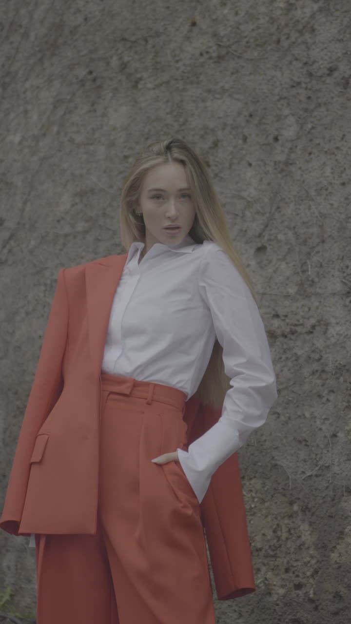 Woman in Orange Pantsuit and White Shirt