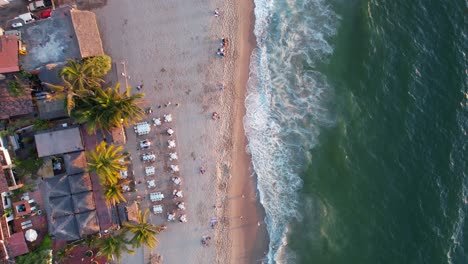 tropical beachfront hotels and resorts at los muertos beach at sunset in puerto vallarta mexico, aerial top down