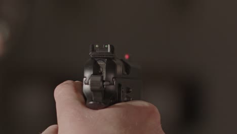 9mm pistol firing a single range with a out of focus background