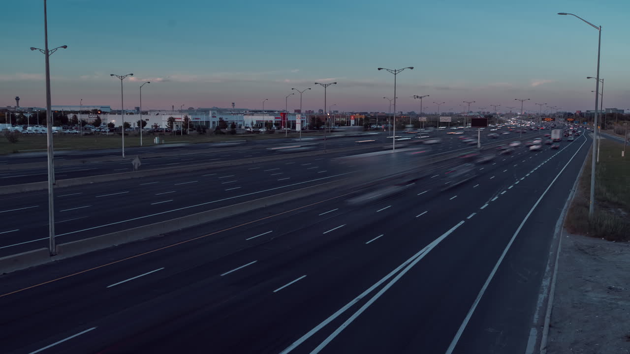 Fast cars on Highway 401 in Ontario during a clear day timelapse