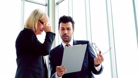 two business people talk project strategy at office