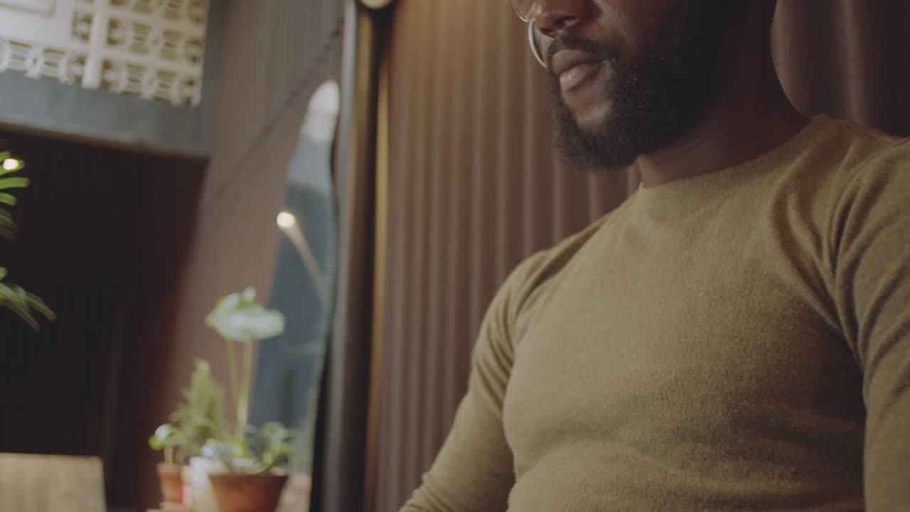 A man is working on his computer inside