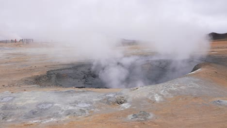 vapor from mud pot in geysir hot springs geothermal area in landscape of iceland