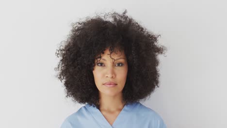 female health worker smiling against white background