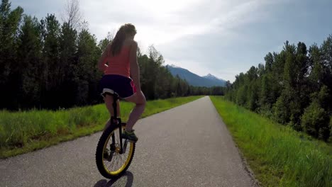 Woman-riding-unicycle-on-the-road-4k