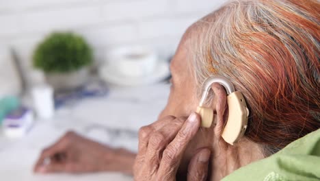 elderly woman with hearing aid