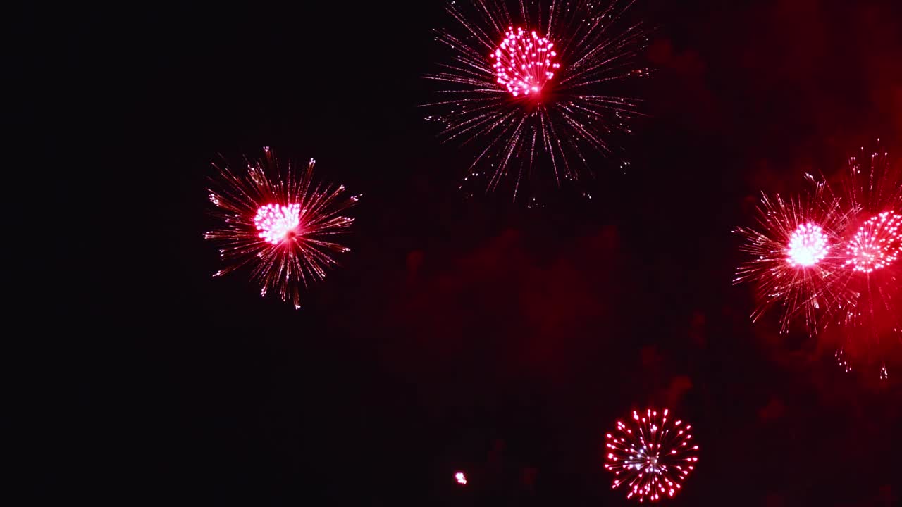 Real fireworks exploding celebration frame fill and loop seamlessly abstract blur bokeh lights in the night sky with the glowing fireworks show festival