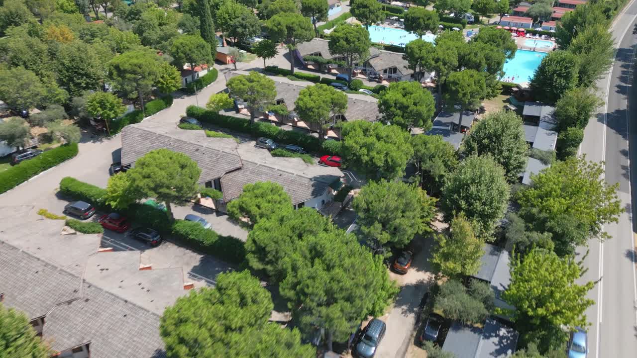 Aerial flyover above condos and swimming pools at lake garda italy