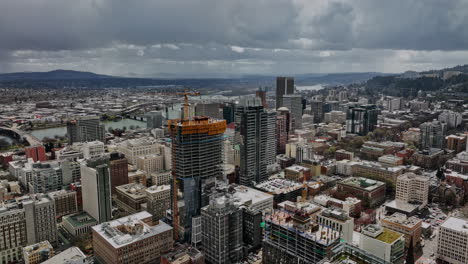 Portland-Oregon-Aerial-v99-flyover-downtown-capturing-urban-cityscape-and-city-new-development-ritz-carlton-hotel-tower-under-construction-with-SW-hillside-views---Shot-with-Mavic-3-Cine---August-2022