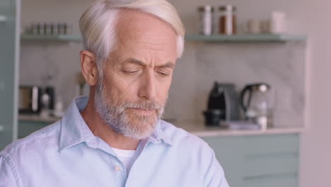 portrait happy old man drinking coffee at home smiling enjoying retirement lifestyle