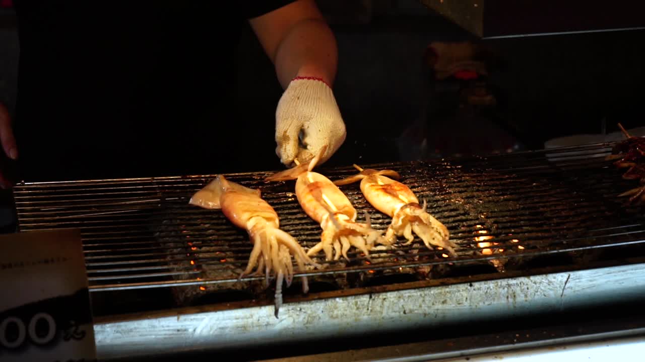 bbq squid on a grill at a street food stall in Taipei, taiwan