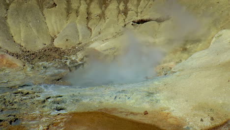 slow motion footage of hot springs, steaming fumaroles and boiling mud pots in seltun geothermal area in iceland