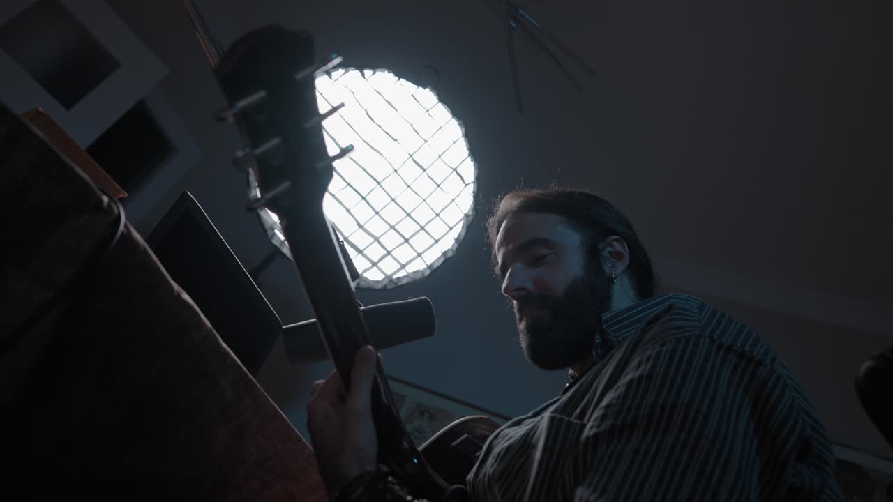 Musician Playing Bass Guitar in Home Studio