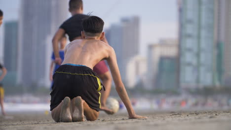 determined boy gets up of floor playing soccer. ambitious and motivated concept.