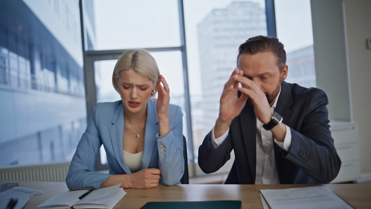 Stressed business partners working laptop at big cabinet closeup. Two losers