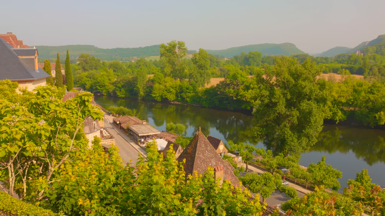 Dordogne River With Lush Green Trees In Beynac, France. - wide shot