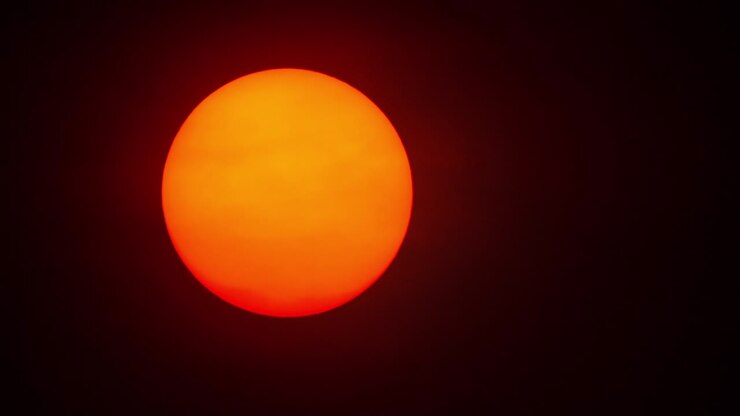 Red sun sphere in thick smog