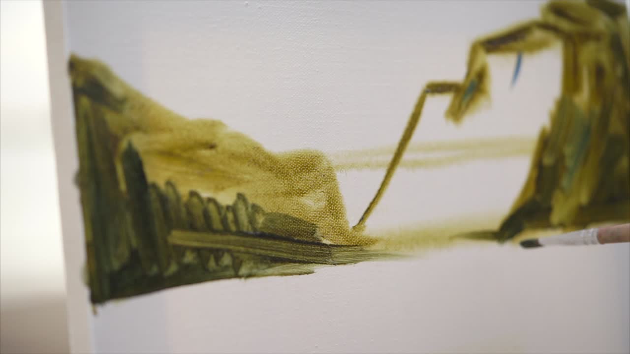 Woman painting with a brush on a canvas