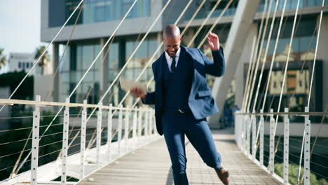 happy businessman celebrating success on a city bridge