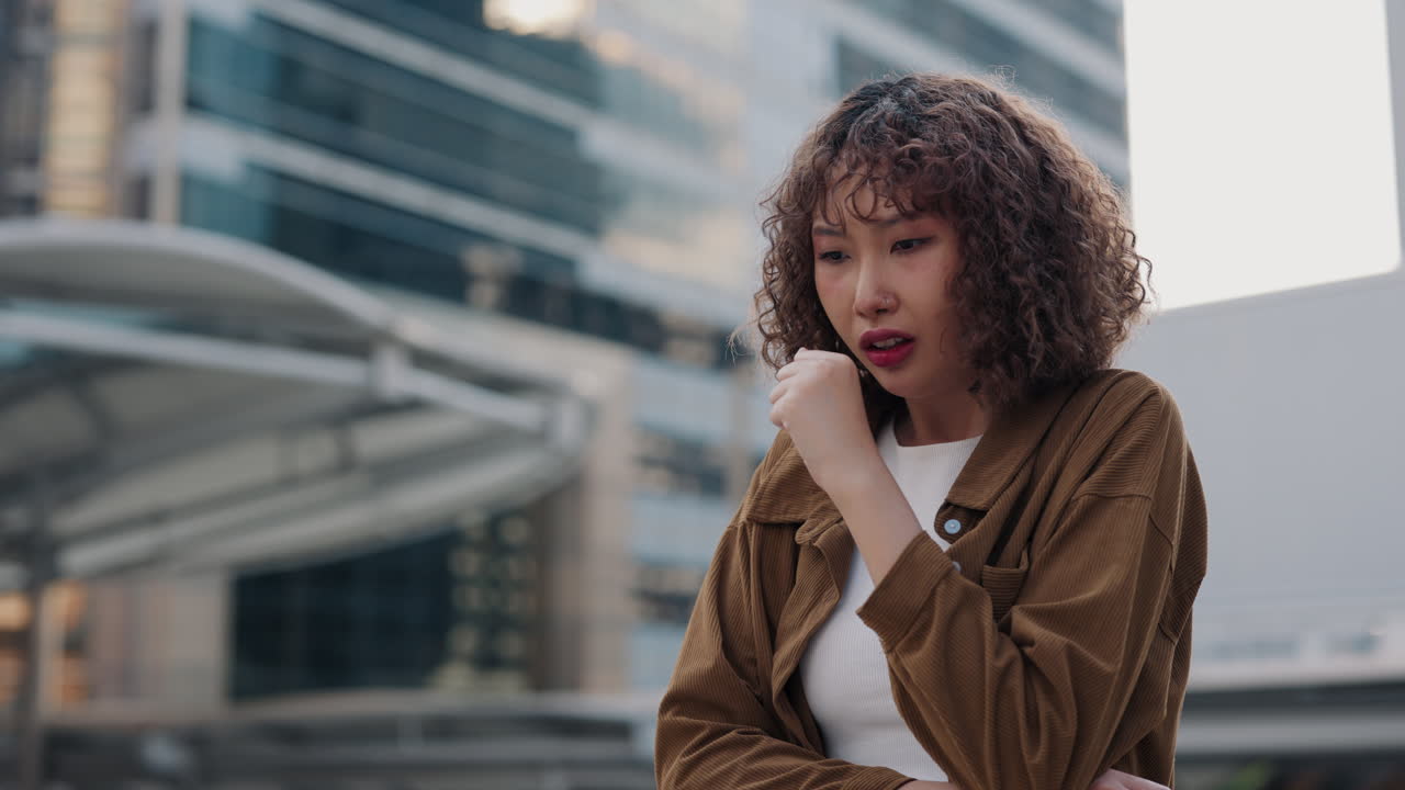 Young Woman Coughing in City