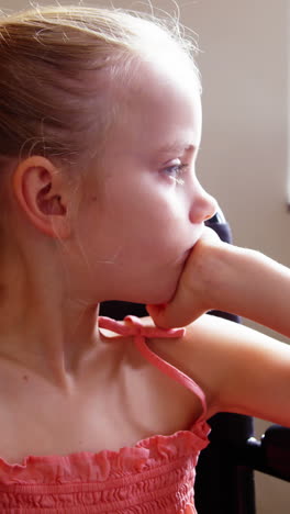 niña discapacitada mirando por la ventana en el aula
