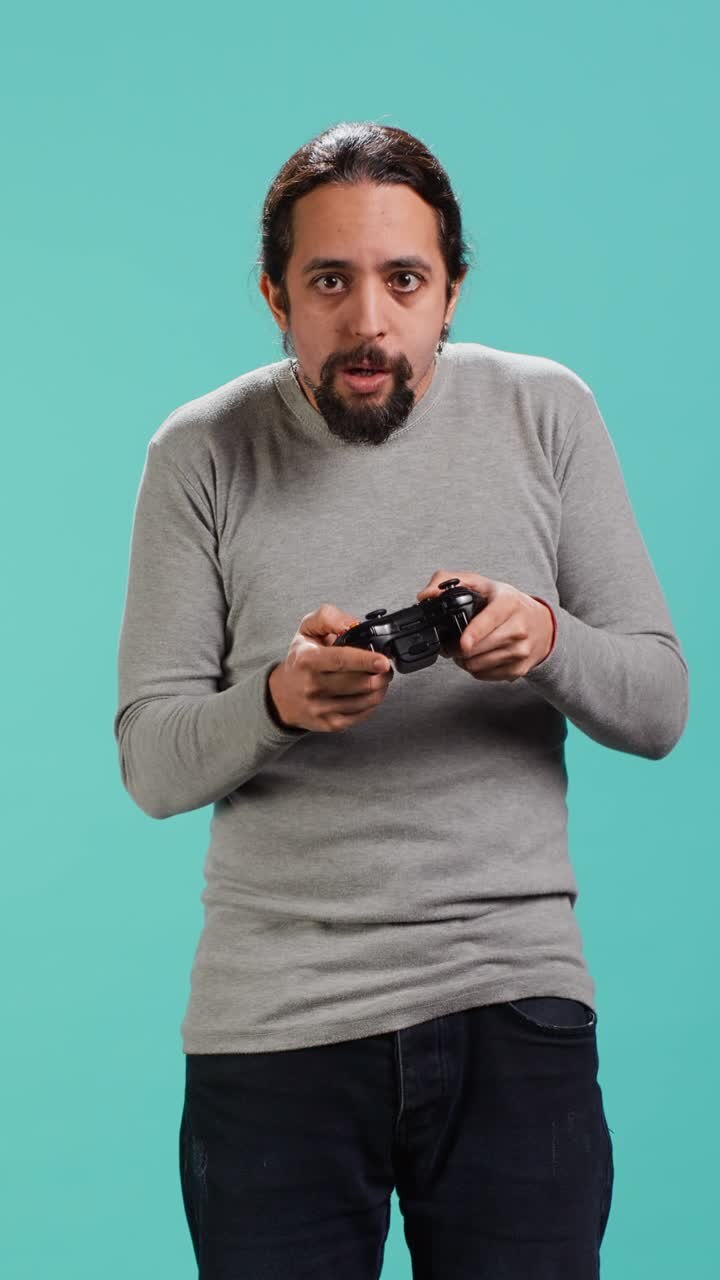 Vertical video Portrait of man playing videogames gaming with controller
