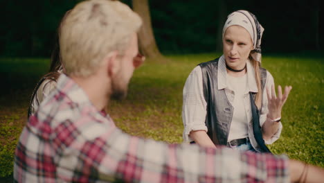 woman wearing bandana talking with friends at park