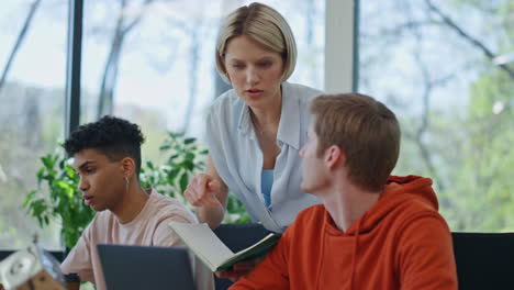 serious mentor consulting man at office close up. corporate woman giving advices