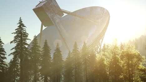 the observatory radio telescope in forest at sunset