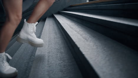 girl legs walking stairs in subway underground station at city street.