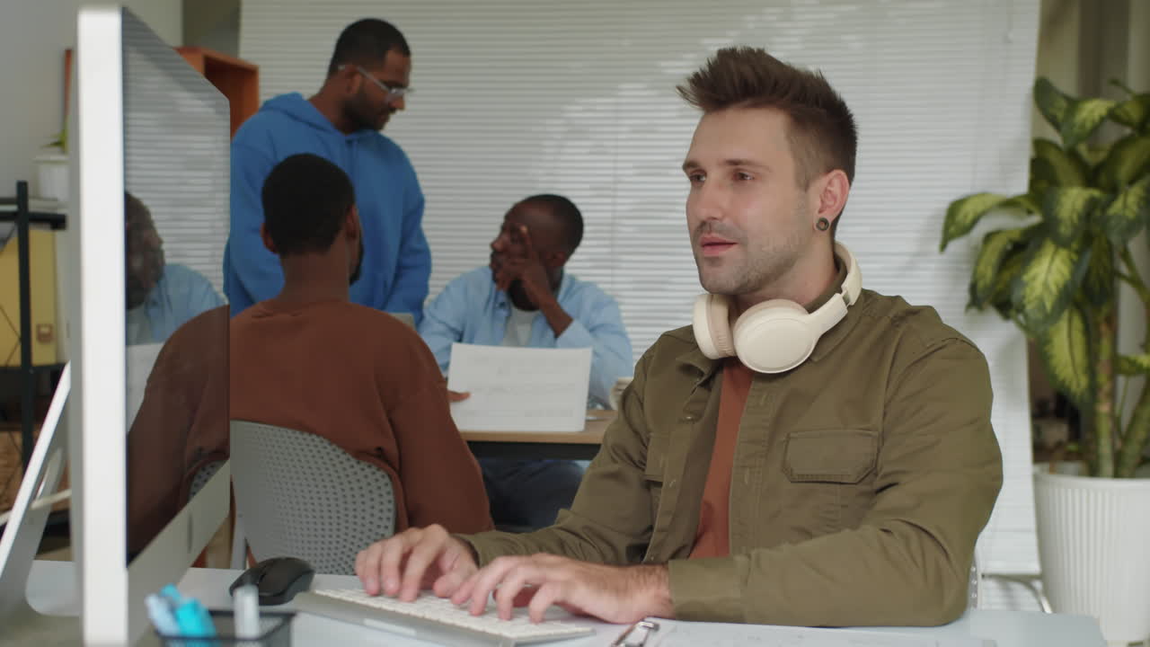 Portrait of Caucasian Programmer Developing App on PC