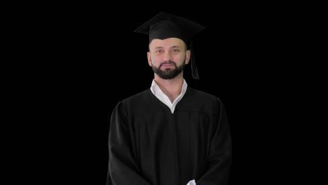 young male smiling graduate showing thumb up,