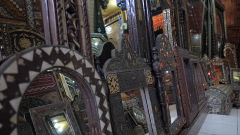 old antique close up of decorative mirrors in moroccans art. carved plaster arabesques, zellige tilework, carved wood