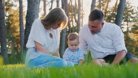 family with a child have a rest in nature communication and a good time together