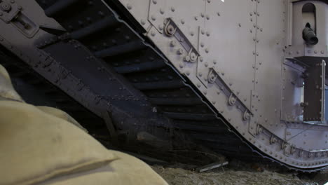 First-world-war-mark-IV-tank-tracks-and-sandbags-withe-WW1-helmet-and-barbed-wire