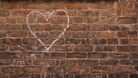 Heart-Drawn-in-Chalk-on-Brick-Wall---Handheld
