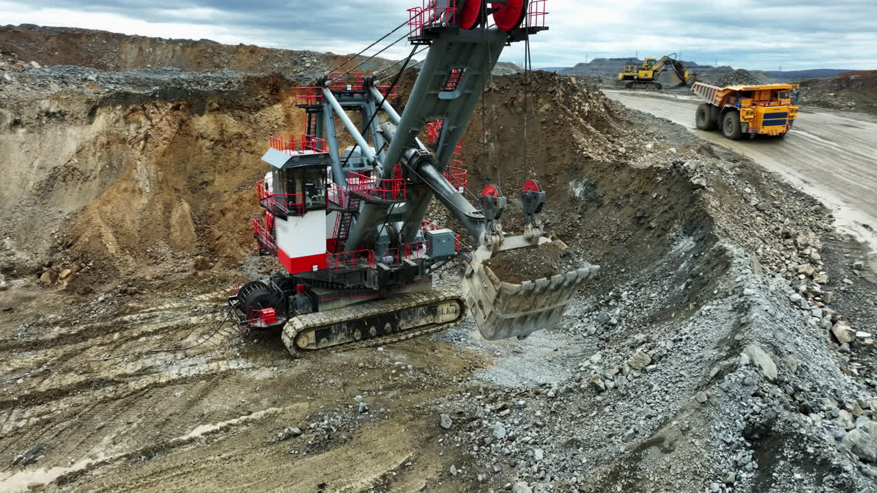Large Mining Excavator Loading Trucks with Gravel