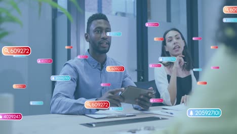 Animation of social media icons against diverse colleagues discussing in meeting room at office