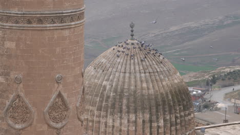 as the camera zooms out, we see the minaret and dome of the mardin grand mosque