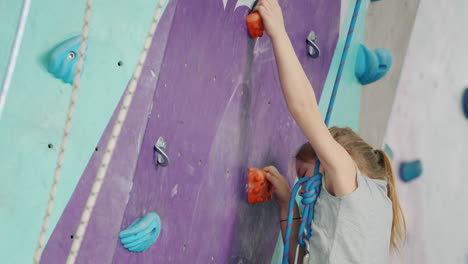 young girl rock climbing